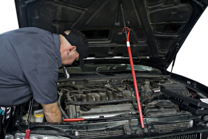 Mechanic inspecting vehicle 